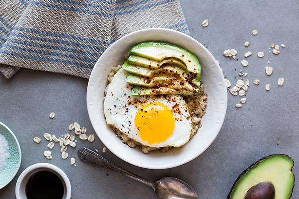 Porridge with Salted Butter, Avocado and a Sunny Side Up Egg